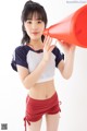 A young woman holding a red megaphone in her hand.